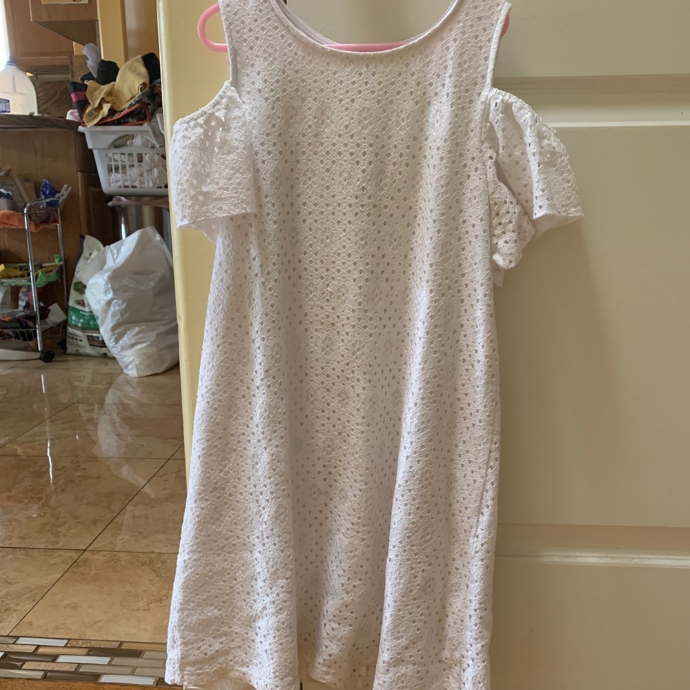 A white dress with shoulder wholes
